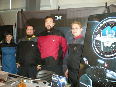 Four Star Trek fans dressed in Starfleet costumes.