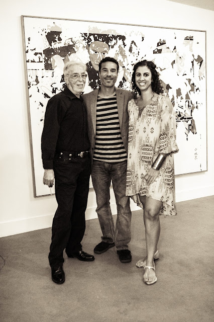 Theo Wujcik standing together with Edgar Sanchez Cumbas and Sophia Nakis Sanchez in front of a painting.