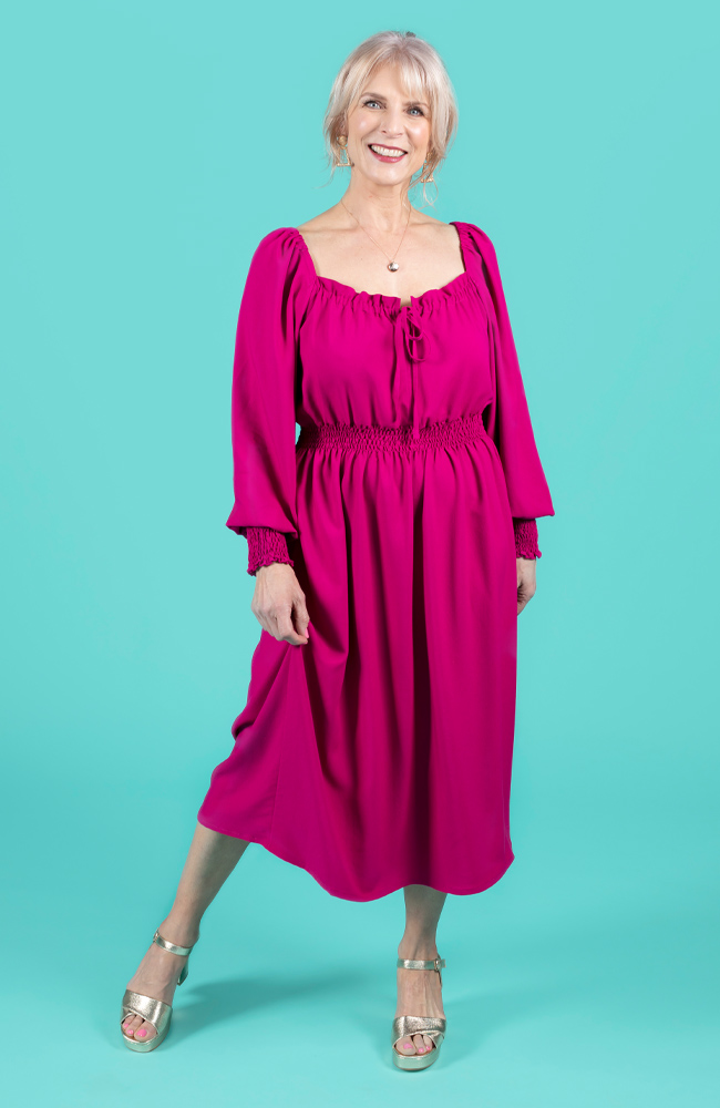 Model wearing a magenta shirred dress, made using Tilly and the Buttons Mabel sewing pattern