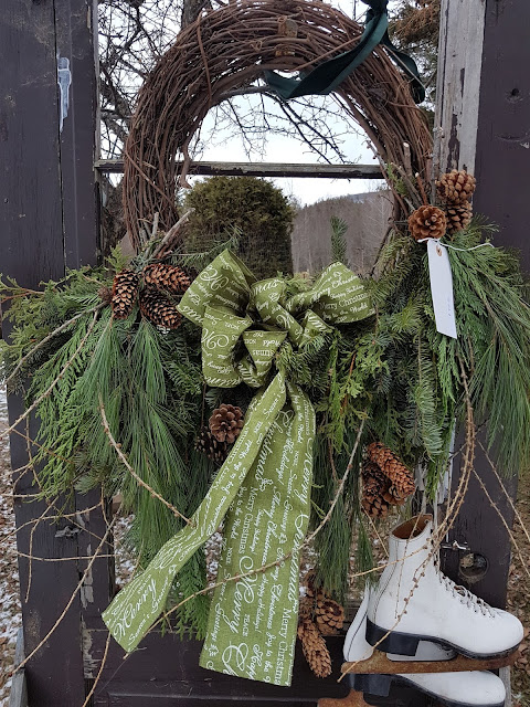 Grapevine wreaths with fresh evergreens and ribbon