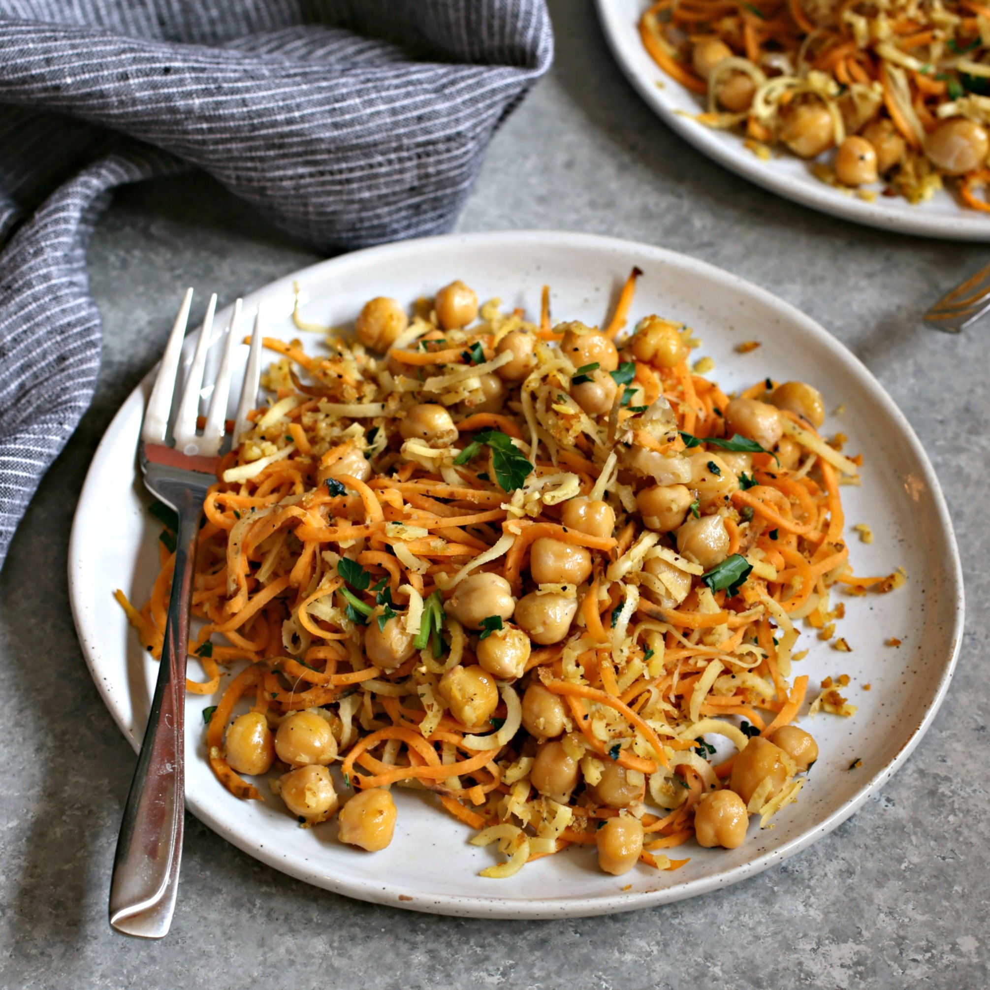 Recipe for spiralized sweet potatoes and parsnips with chickpeas and a crispy breadcrumb topping.