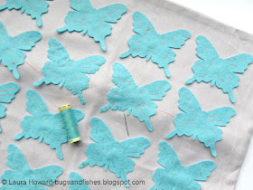 sewing the felt butterflies to the cushion cover