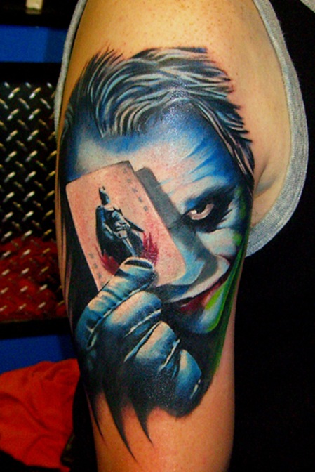 Movie joker tattoo with playing card.
