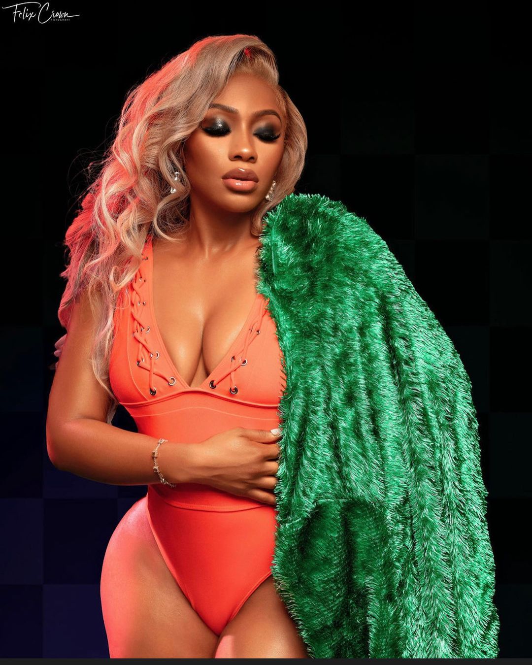 Green jacket anf orangr swimsuit Mercy Eke's 29th Birthday Look