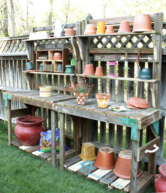 potting bench made out of a playset with lots of planters on it.