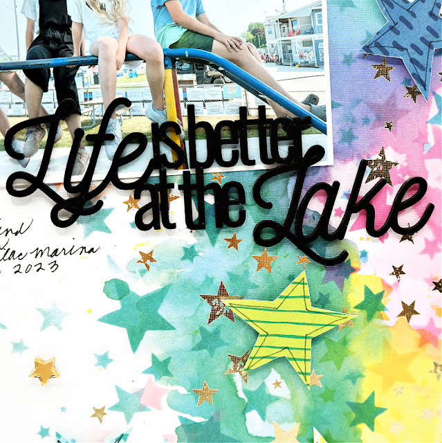 Life is Better at the Lake painted chipboard title on a rainbow stars mixed media summer scrapbook layout.