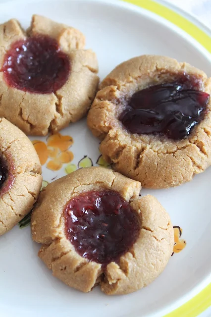 Serving plate with peanut butter and jelly thumbprint cookies.