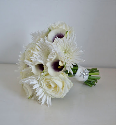 Kirsty's white and purple wedding bouquet finished with a diamante flower