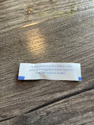 Fortune cookie that reads A real patriot is a fellow who gets a parking ticket and rejoices that the system works.