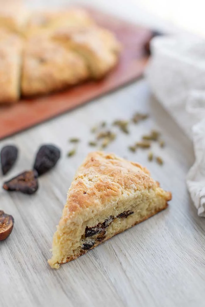 How to make a fig and cardamom scone recipe in a cast iron skillet (or other pan). This American scones recipe has buttermilk to make a soft, fluffy and moist dessert. Serve with coffee or tea for an afternoon treat or after dinner. This is the best scones recipe and is baked in the oven instead of fried. This makes a great treat for Christmas with the figs. #scones #fig #dessert #recipe