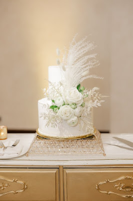 two tierwhite wedding cake with floral and dried boho floral