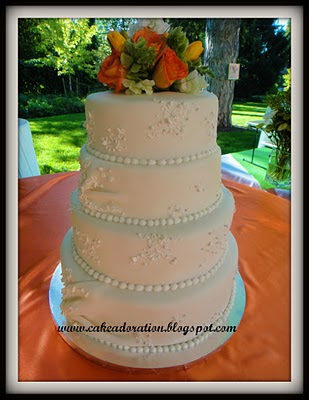 This elegant White Wedding Cake was patterned after the Brides Wedding Dress