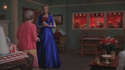 Sue wearing a blue tracksuit dress, it is as hideous as it sounds