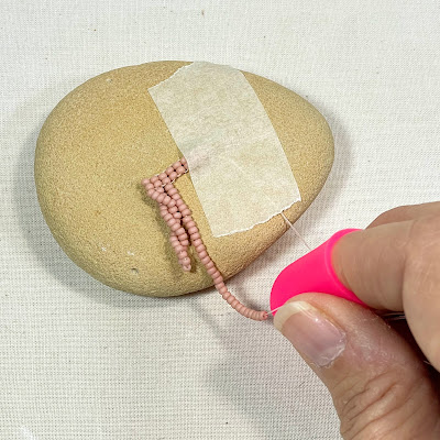 Twisting the thread to make twisted bead fringe