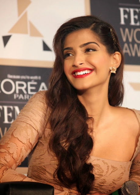 Sonam Kapoor looking radiant in a hot pink outfit, exuding confidence.