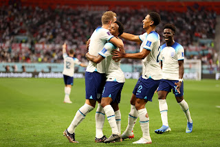 Raheem Sterling celebrates goal with teammates, Harry Kane and Jude Bellingham as England wallops Iran 6-2