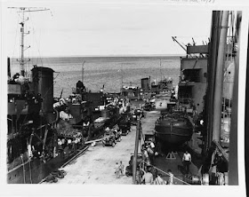 USS Tangier and other ships unloading supplies at Midway Island, 26 December 1941 worldwartwo.filminspector.com