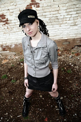 Raivyn - photo by Ed Haardt - Negativ3arth, Demonia zip-off boots, Jagermeister hat, metal chain bracelet, camo industrial skirt, industrial alt model