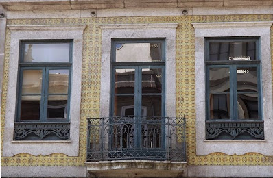 fachada com azulejos amarelos no Porto com varanda e duas janelas