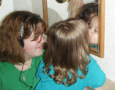 Teen laughing at Toddler kissing Self