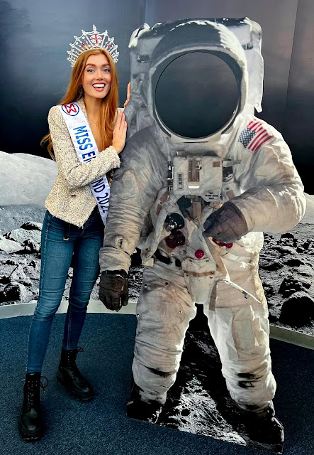 Beauty queen standing next to astronaut