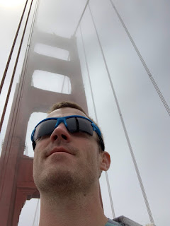 Farmer man in blue sunglasses on the golden gate bridge with fog behind