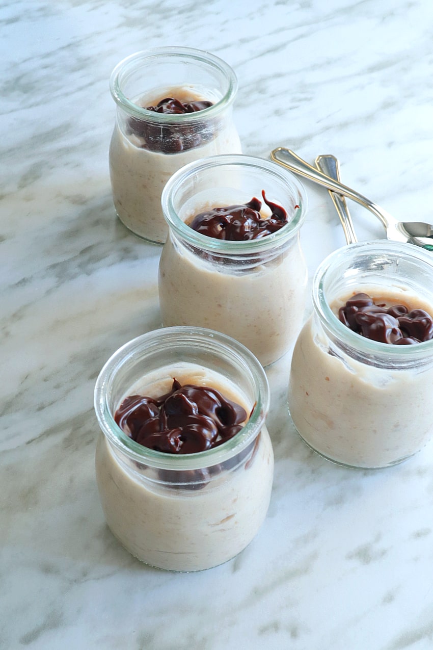 several small jars filled with chestnut mousse topped with melted chocolate