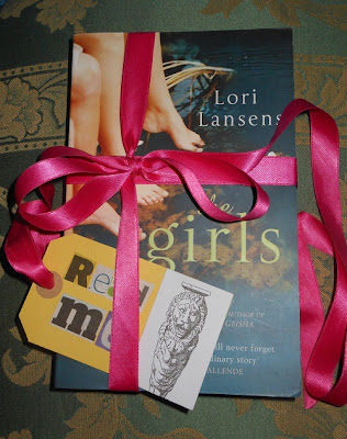 'The-Girls'-wrapped-in-pink-ribbon-with-'read-me'-label-ready-to-be-released-by-Books-in-the-Wild.