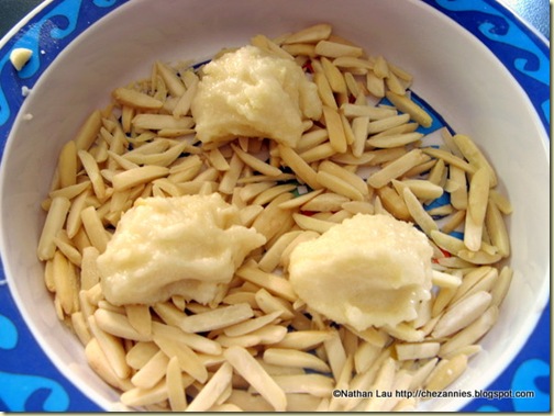 rolling cookie dough in slivered almonds