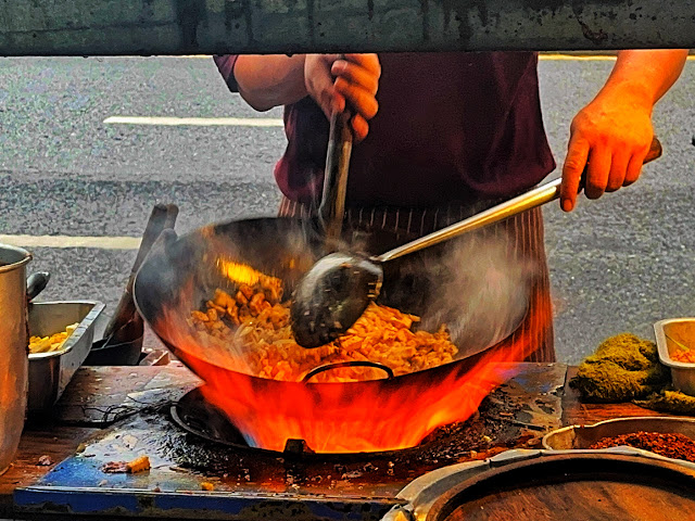 pad Thai cooked over a flaming wok in Bangkok, Thailand