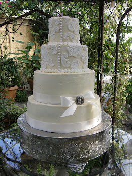 4-tier round buttercream with fondant appliques