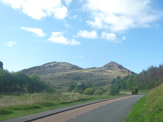 a view of Arthur's Seat with a road in the foreground