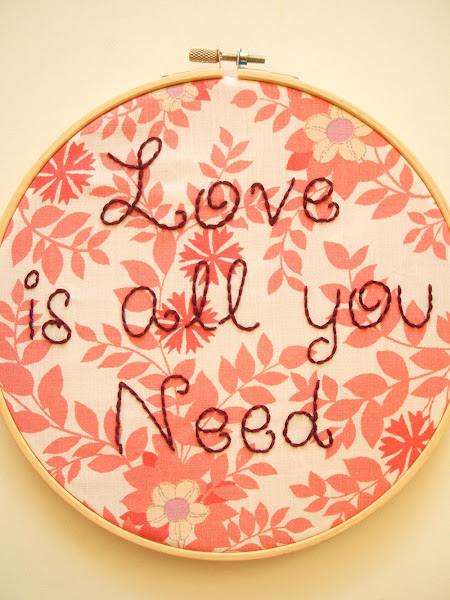 hand embroidered wall art hoop featuring Beatles love is all you need song lyrics on vintage fabric