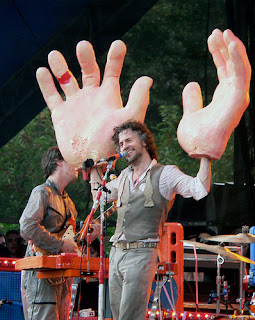 Wayne Coyne of The Flaming Lips performing with giant hands