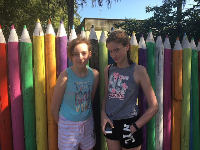 stephs two girls by pencil fence in center parcs