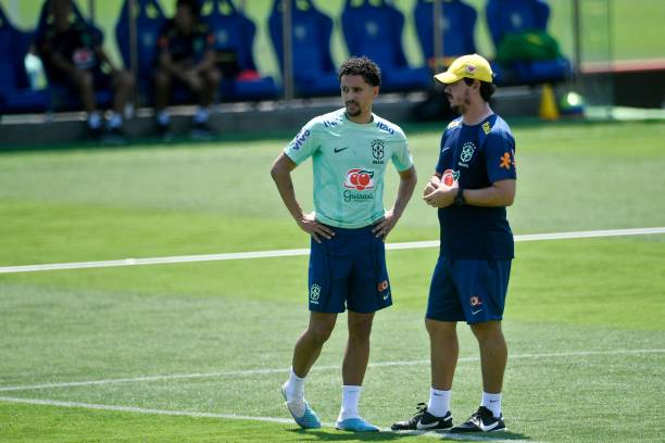 Brazil's defender Marquinhos (L) talks to coach Fernando Diniz