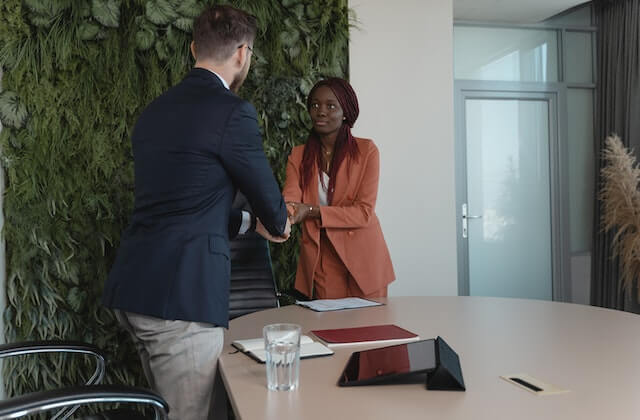 Woman shaking hands with recruiter at the office