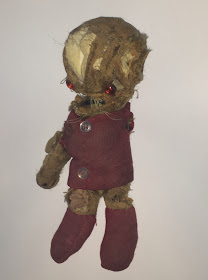 Well-worn, torn, patched old teddy bear