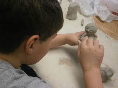 Student building clay warrior for terracotta warrior art lesson