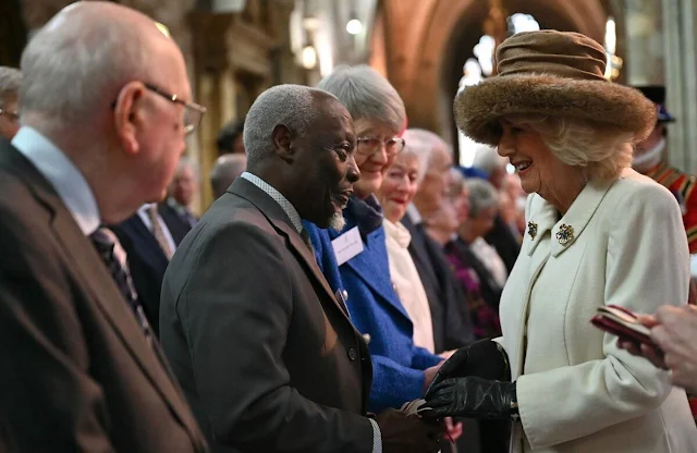 Queen Camilla wore a white wool coat. The Queen presented Maundy Money to 75 men and 75 women in Worcester
