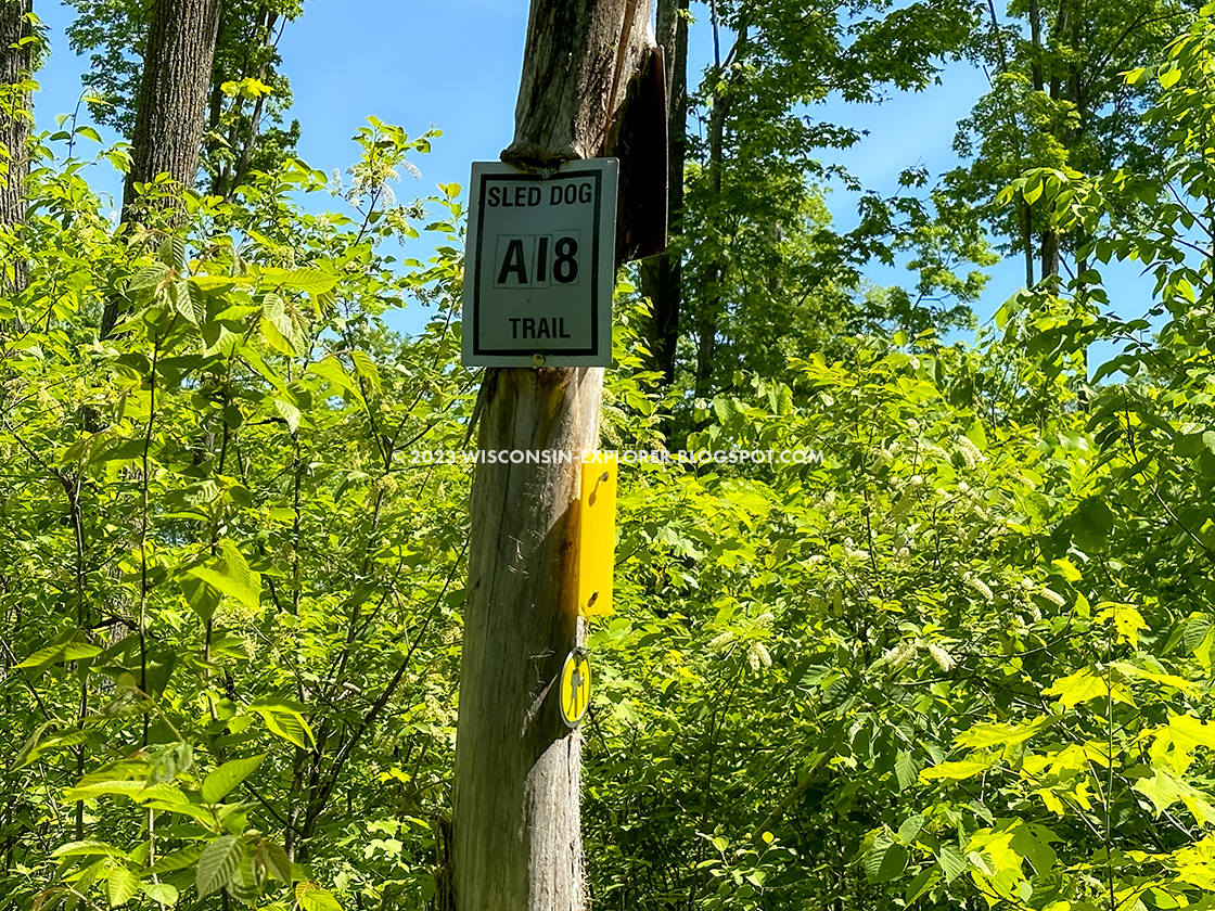 sled dog trail sign on post