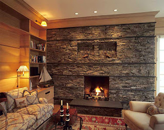 small stoned fireplace with brown sofas on red moroccan rug also yellow lighting idea