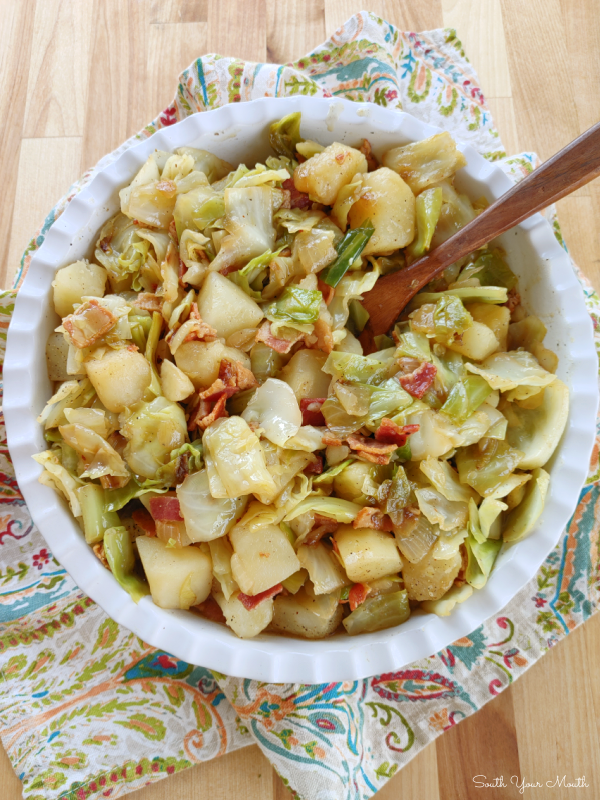 Southern-Style Smothered Cabbage & Potatoes! A simple homestyle recipe for tender potatoes smothered in fried cabbage and onions cooked with bacon.