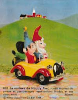 Picture of Noddy and Big Ears driving in a little yellow and red toy car.