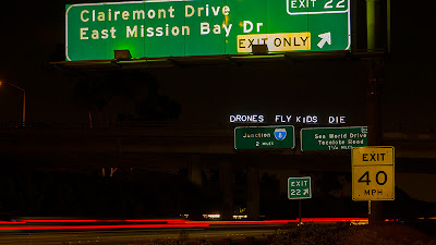 "DRONES FLY KIDS DIE" - Overpass Light Brigade