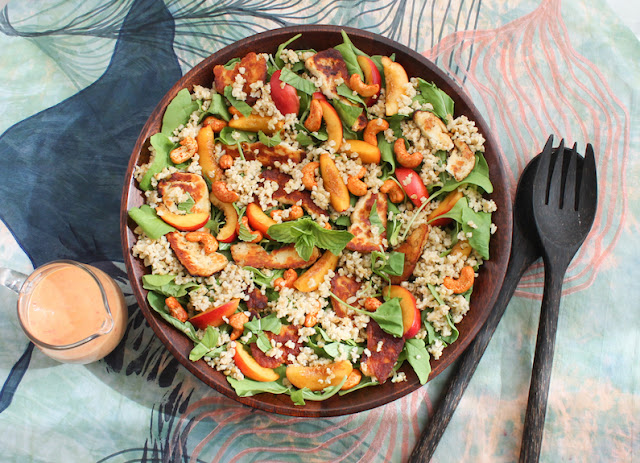 Food Lust People Love: This halloumi freekeh peach salad features pan-fried salty cheese, nutty freekeh and sweet peaches along with baby arugula and spicy cashews for a delightfully fresh and filling meal. Drizzle it with chili peach vinaigrette or your favorite dressing.