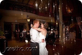 Bride and groom's first dance with falling rose petals at Galagos