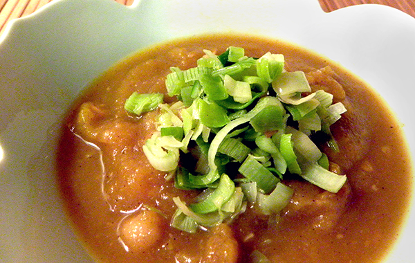 Bowl of Moroccan pumpkin soup topped with sauteed leeks