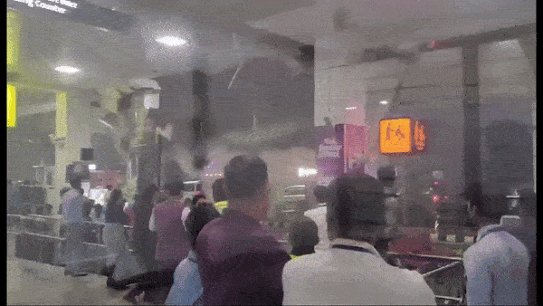 Due to heavy rain, a portion of the Guwahati airport's roof collapses, delaying flights Scene