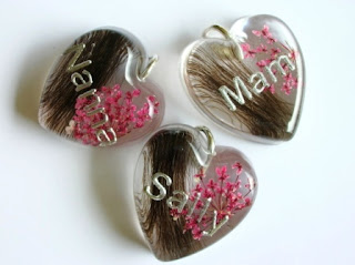 Personalised pendants containing preserved hair and flowers